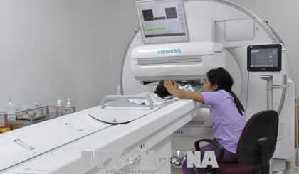 Bệnh nhi đầu tiên chuẩn bị được xạ hình. Ảnh: TTXVN