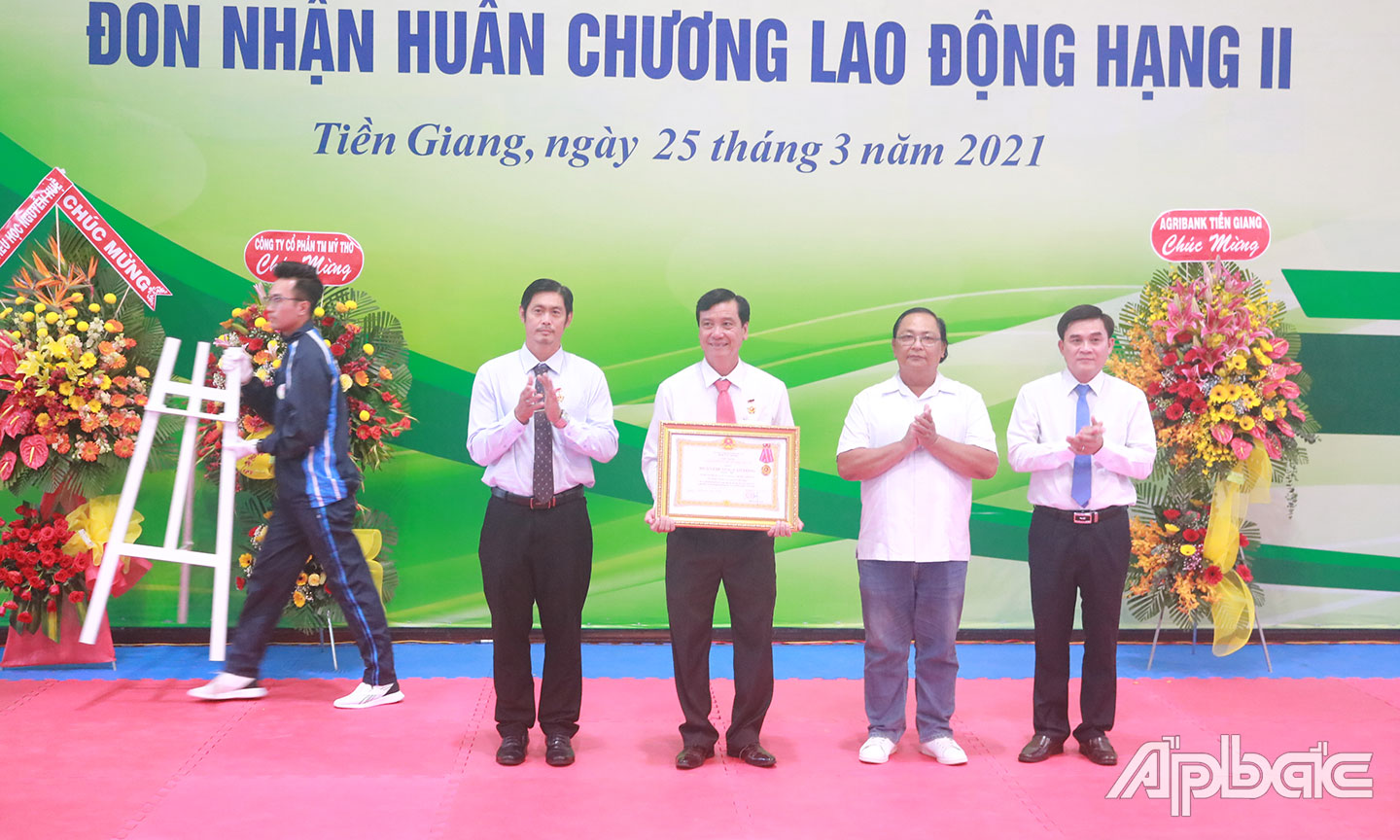 Đồng chí Nguyễn Văn Mười (bìa phải) thừa ủy quyền Chủ tịch nước trao Huân chương Lao động hạng Nhì cho Trung tâm.