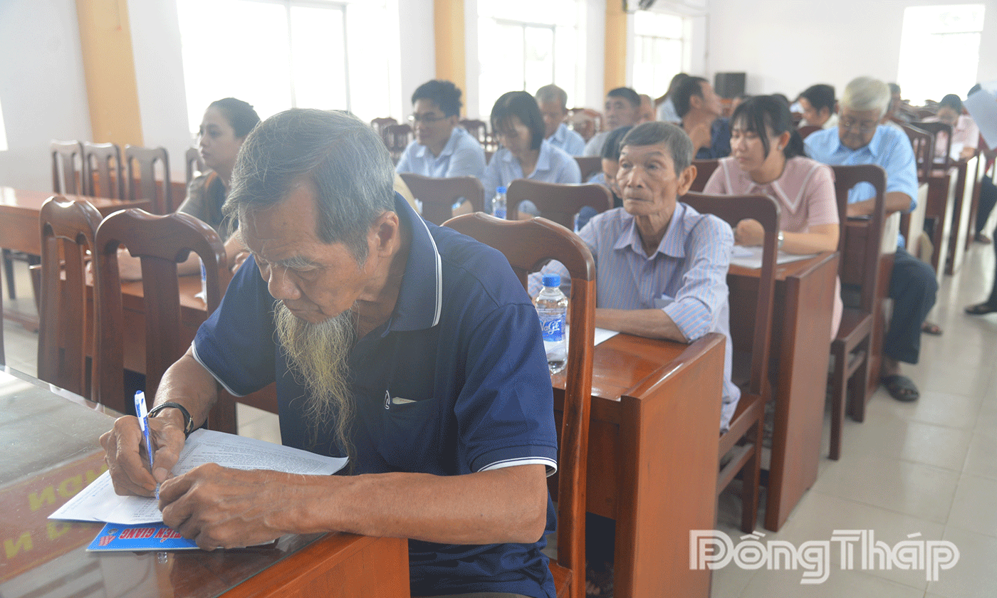 Nông dân phường Đạo Thạnh trả lời vào phiếu xin ý kiến. 