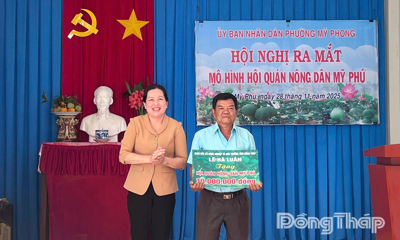 đồng chí Trần Thị Bé Bảy, Phó Giám đốc Sở Nông nghiệp và Môi trường tỉnh trao kinh phí hỗ trợ cho Hội quán nông dân Mỹ Phú